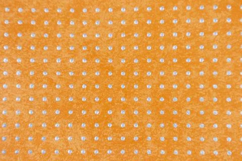 The surface is covered in a mixture of white and orange polka dots, an abst.. 스톡 사진