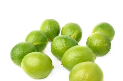 Surface covered with multiple ripe limes, composition isolated over the white Stock Photos