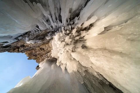 A surface covered with a thick layer of cracked ice. Stock Photos