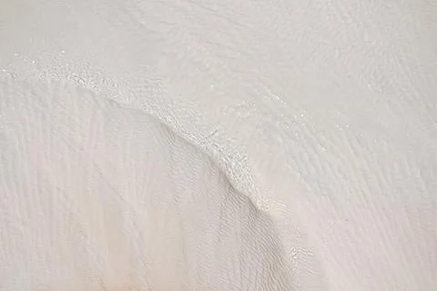 The surface is covered with travertine deposits. Stock Photos