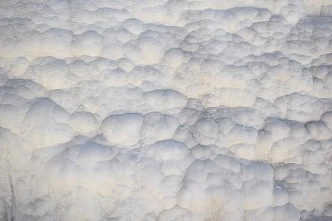 The surface is covered with travertine deposits. Фото