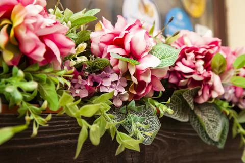 Surface decorated with artificial flowers Stock Photos