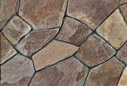 Surface decorated with flat gray wild stone. Stock Photos
