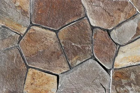 The surface is decorated with flat grey wild steppe stone. Stock Photos