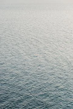 Surface of the deep blue sea in sunset light Stock Photos