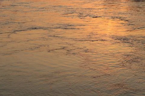 Surface of Elbe river in Dresden reflecting light at sunset Stock Photos