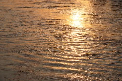 Surface of Elbe river in Dresden reflecting light at sunset Stock Photos