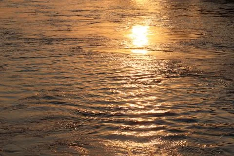 Surface of Elbe river in Dresden reflecting light at sunset Stock Photos