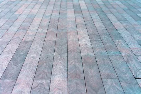 The surface with elongated rectangular stone tiles goes into perspective. 스톡 사진