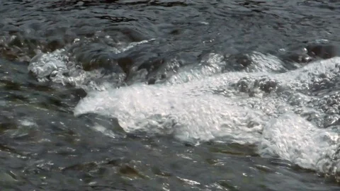 Surface of a fast flowing freshwater stream with bubbles Stock Footage 113587856