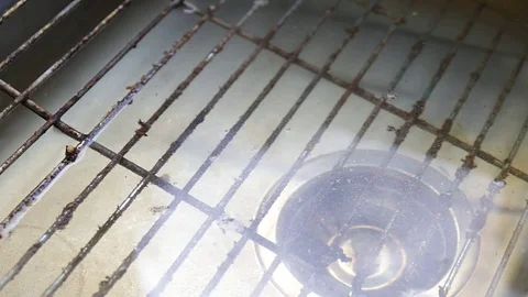 The surface of a filthy grill rack submerged in kitchen sink. Stock Footage 74889291