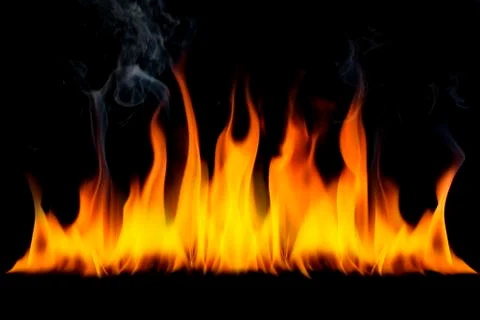 The surface of the fire and the burning smoke are hot on a black background. Stock Photos