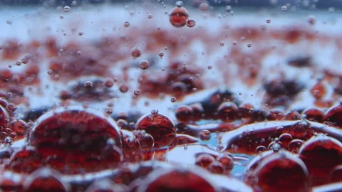 Surface of the floating red droplets on which continue to drip the same drops Stock Footage 132188470