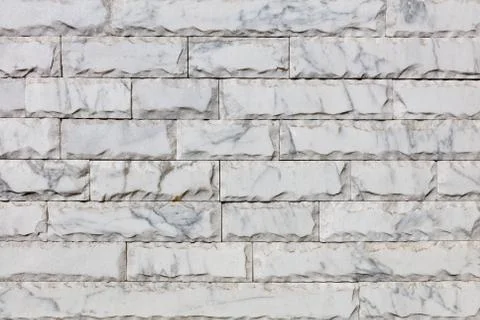 Surface of gray marble tiles, each chipped along the perimeter, with cracks. Stock Photos