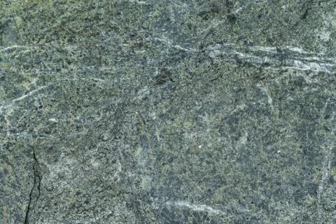 Surface grey granite stone with light lines and streaks. Stock Photos