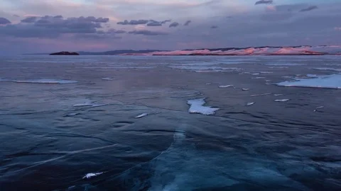 The surface of the ice on the frozen lake in the rays of the setting sun. Stock Footage 73390033