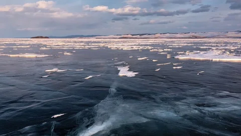 The surface of the ice on the frozen lake in the rays of the setting sun. Stock-Footage 73402912