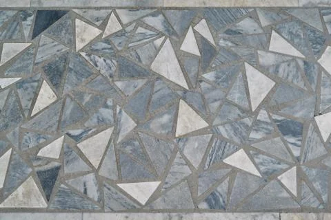 The surface is laid with a mosaic of triangular tiles of various sizes. 写真素材