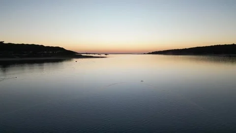 Surface of a lake in the rays of the sunset Stock Footage 299140180