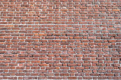 The surface of a large brick wall of a red brick building. Foto stock