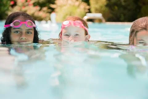 Surface level view of faces of girls in swimming pool Stock Photos