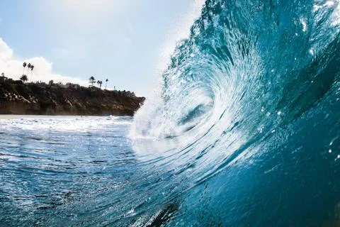 Surface level view of rolling ocean wave and coastline. Encinitas, California, Stock Photos