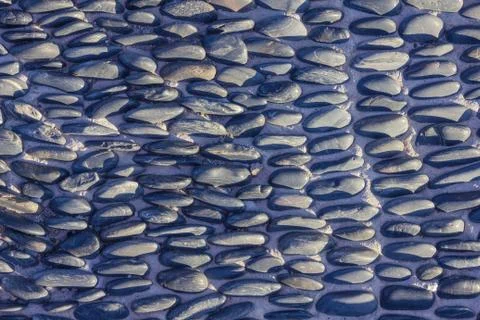 Surface lined with pebbles. Stock Photos