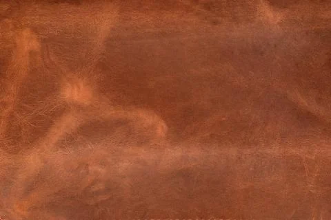 Surface is made of genuine brown leather. Abstract background. Stock Photos