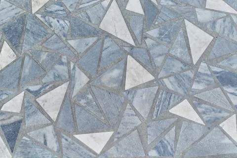 The surface is made of marble tiles in the form of triangles. Stock Photos