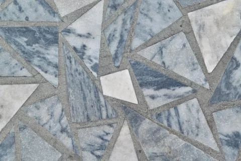 The surface is made of marble tiles in the form of triangles and polygon. Stock Photos