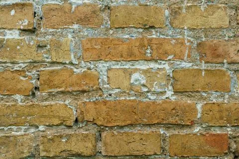 The surface is made of old red brick. A wall of old historical buildings made Stock Photos