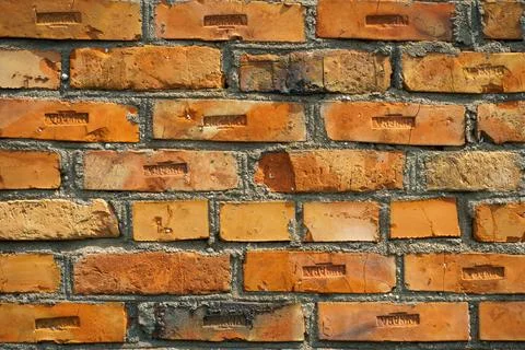 The surface is made of old red brick. A wall of old historical buildings made Stock Photos