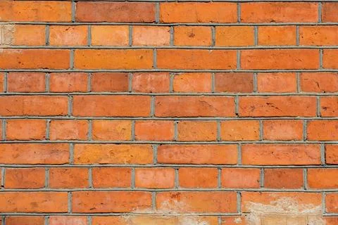 The surface is made of old red brick. A wall of old historical buildings made Stock Photos