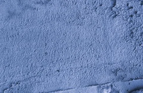 The surface is made of old unevenly applied blue plaster. Stock Photos