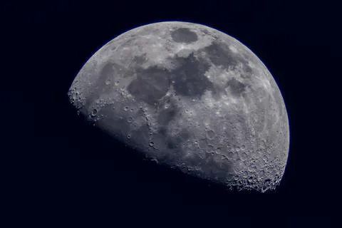 Surface of the Moon on black background, close up. Stock Photos