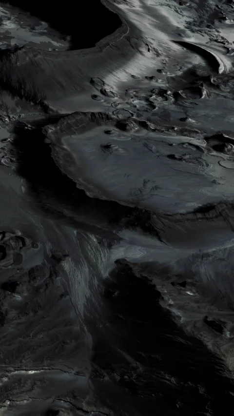 Surface of a moon showing craters and dark terrain under dim light Stock Footage 344959849