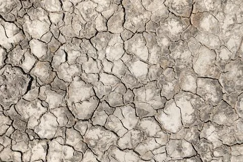 Surface of mud cracked from drought as a background Stock Photos