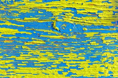 Surface with multicolored paint flaking and cracking background texture Stock Photos