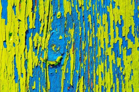 Surface with multicolored paint flaking and cracking background texture Stock Photos