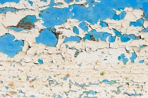 Surface with multicolored paint flaking and cracking background texture Stock Photos