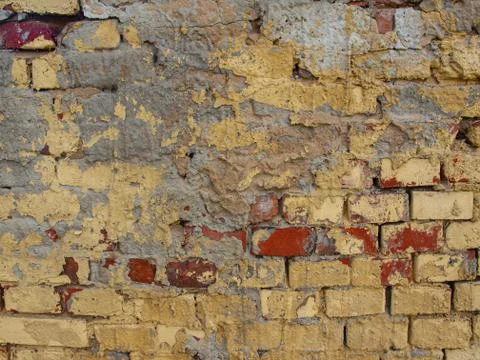 Surface of old bricks color plastered and cracked Stock Photos