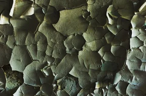 A surface with an old cracked paint splitting large pieces Stock Photos