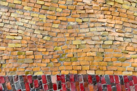 Surface of old crumbling abstract decorative mosaic with orange and red color Stock Photos
