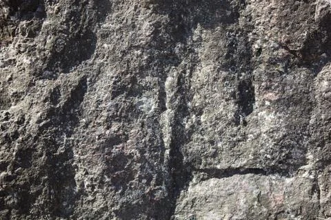 Surface of the old granite stone as a backdrop. Stock Photos