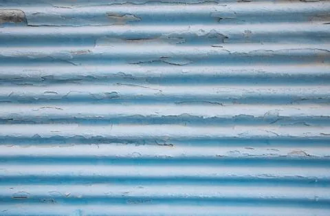 Surface of an old painted blue tin background with panels. Stock Photos