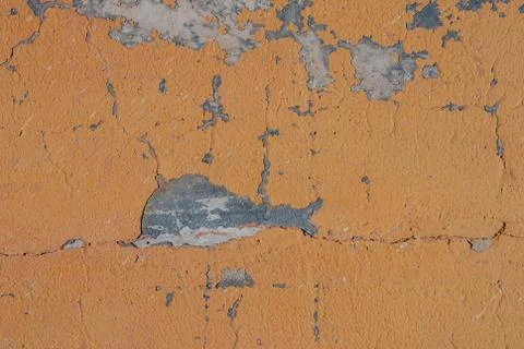 Surface of the old wall with exfoliating and falling off paint as a backgroun Stock Photos