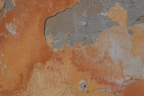 Surface of the old wall with exfoliating and falling off paint as a backgroun Stock Photos