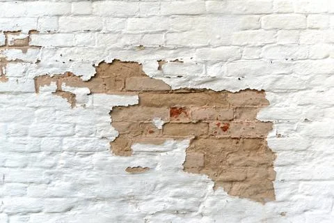 Surface of old wall of weathered bricks with white stucco Stock Photos