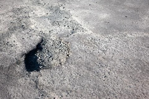 Surface of pavement with a deep hole Stock Photos