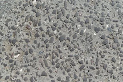 The surface of the pavement laid small different smooth stones. Stock Photos